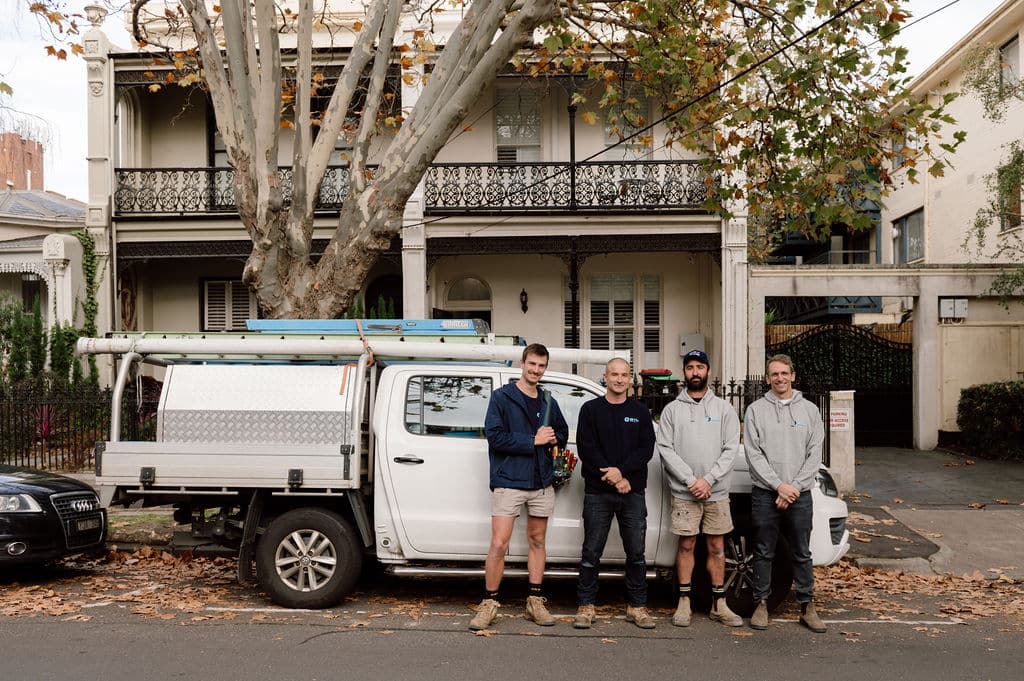 Three STL Electrical electricians standing in front of the company van